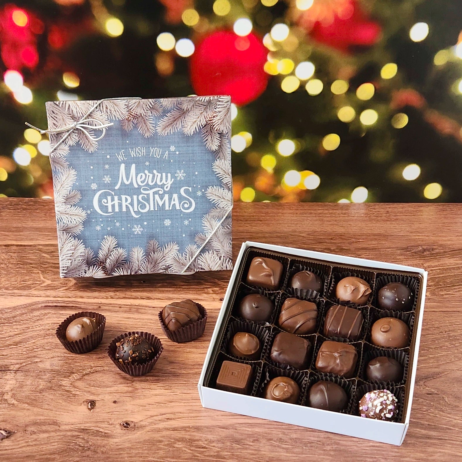 We Wish you A Merry Christmas 16 Piece Chocolate Assortment.  Inside this festive box is a handpicked selection of our most popular milk and dark chocolates.   You’ll discover a variety of gooey caramels, rich truffles, creamy centers, and smooth melt-aways