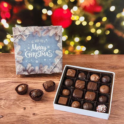 We Wish you A Merry Christmas 16 Piece Chocolate Assortment.  Inside this festive box is a handpicked selection of our most popular milk and dark chocolates.   You’ll discover a variety of gooey caramels, rich truffles, creamy centers, and smooth melt-aways