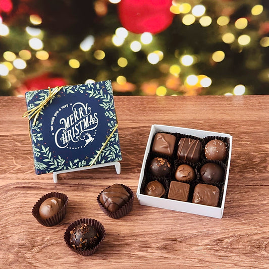 We Wish you A Merry Christmas 9 Piece Chocolate Assortment.  Inside this festive box is a handpicked selection of our most popular milk and dark chocolates.   You’ll discover a variety of gooey caramels, rich truffles, creamy centers, and smooth melt-aways