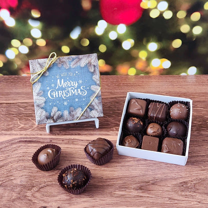 We Wish you A Merry Christmas 9 Piece Chocolate Assortment.  Inside this festive box is a handpicked selection of our most popular milk and dark chocolates.   You’ll discover a variety of gooey caramels, rich truffles, creamy centers, and smooth melt-aways