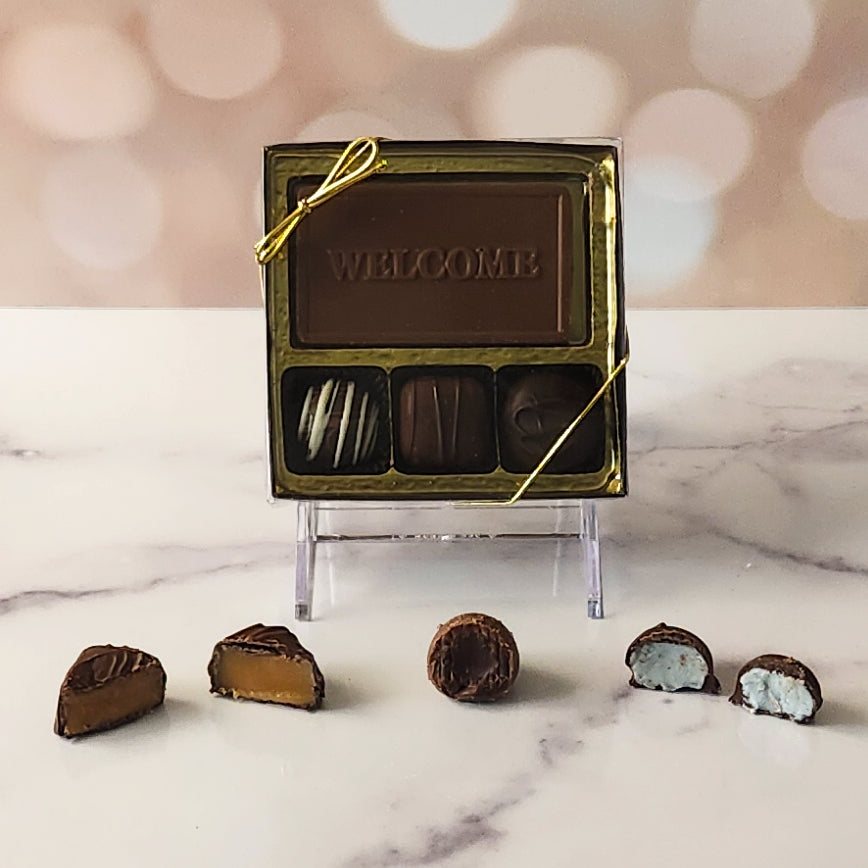 Give a warm greeting with our 3-piece Welcome Candy Box! Inside, a beautifully crafted milk chocolate card that says "Welcome" is paired with a smooth soft center cream, an indulgent truffle, and a delicious caramel. It's the perfect small treat to make anyone feel truly special and appreciated!