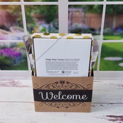 Our Welcome Gift Basket is filled with thoughtful treats  including: 
Milk, Dark & White Chocolate Sea Shells,  Milk Chocolate Nonpareils,  Dark Chocolate Covered Cranberries,  Two Chocolate Covered Oreos, a "Welcome" Milk Chocolate Bar and a 16-Piece Chocolate Assortment – filled with creams, caramels, meltaways, and truffles.  All overwrapped with a bow and ready for gifting.