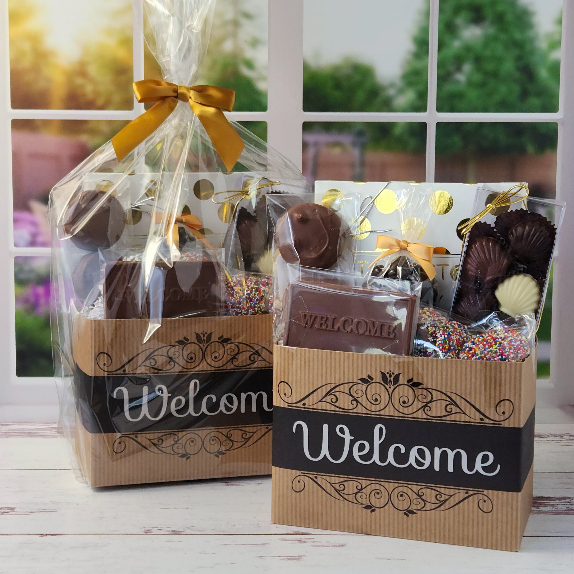 Our Welcome Gift Basket is filled with thoughtful treats  including: 
Milk, Dark & White Chocolate Sea Shells,  Milk Chocolate Nonpareils,  Dark Chocolate Covered Cranberries,  Two Chocolate Covered Oreos, a "Welcome" Milk Chocolate Bar and a 16-Piece Chocolate Assortment – filled with creams, caramels, meltaways, and truffles.  All overwrapped with a bow and ready for gifting.
