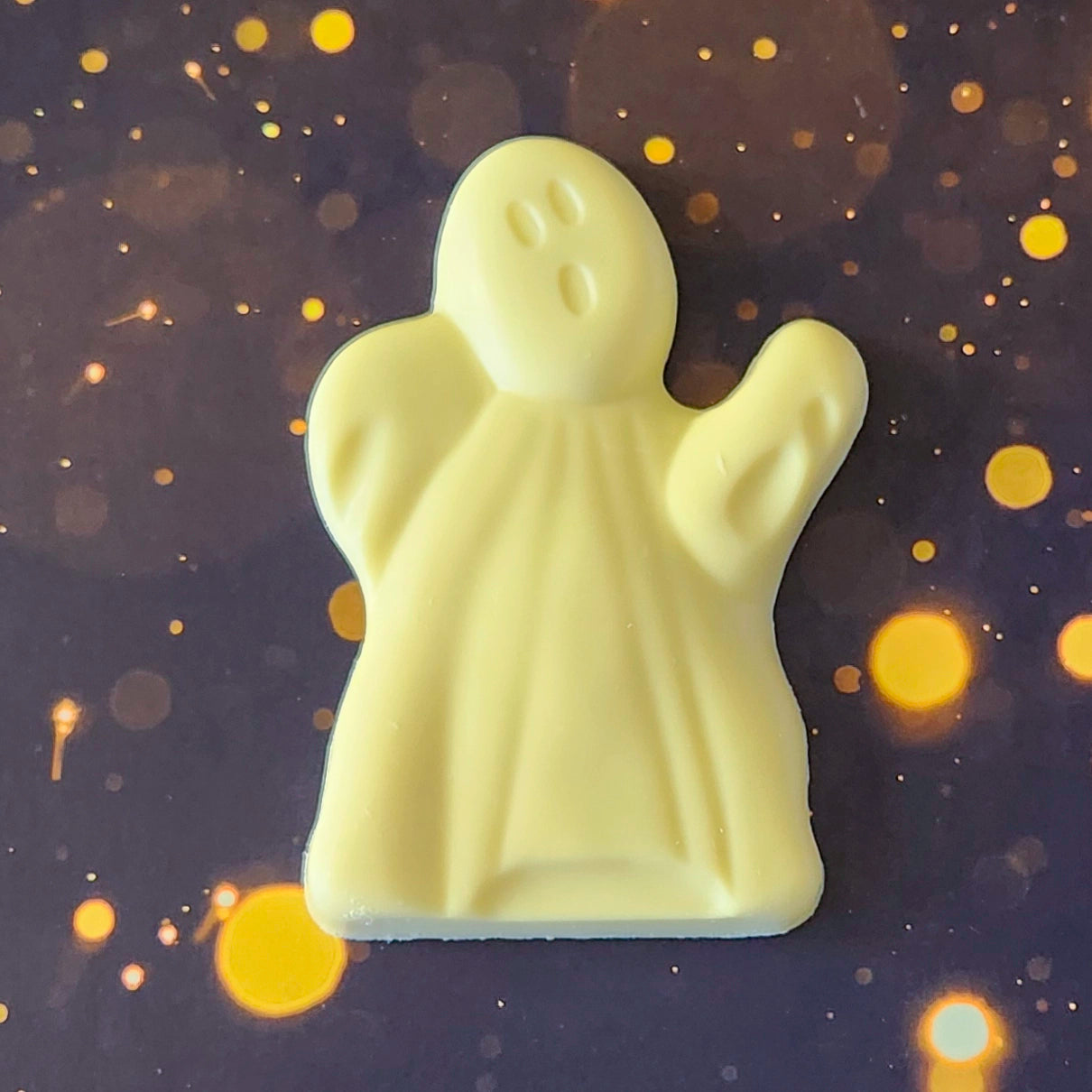 One Haunted Chocolate Ghost made of white chocolate.  Comes packaged in a clear bag tied with an orange bow, showcasing its festive Halloween theme. 