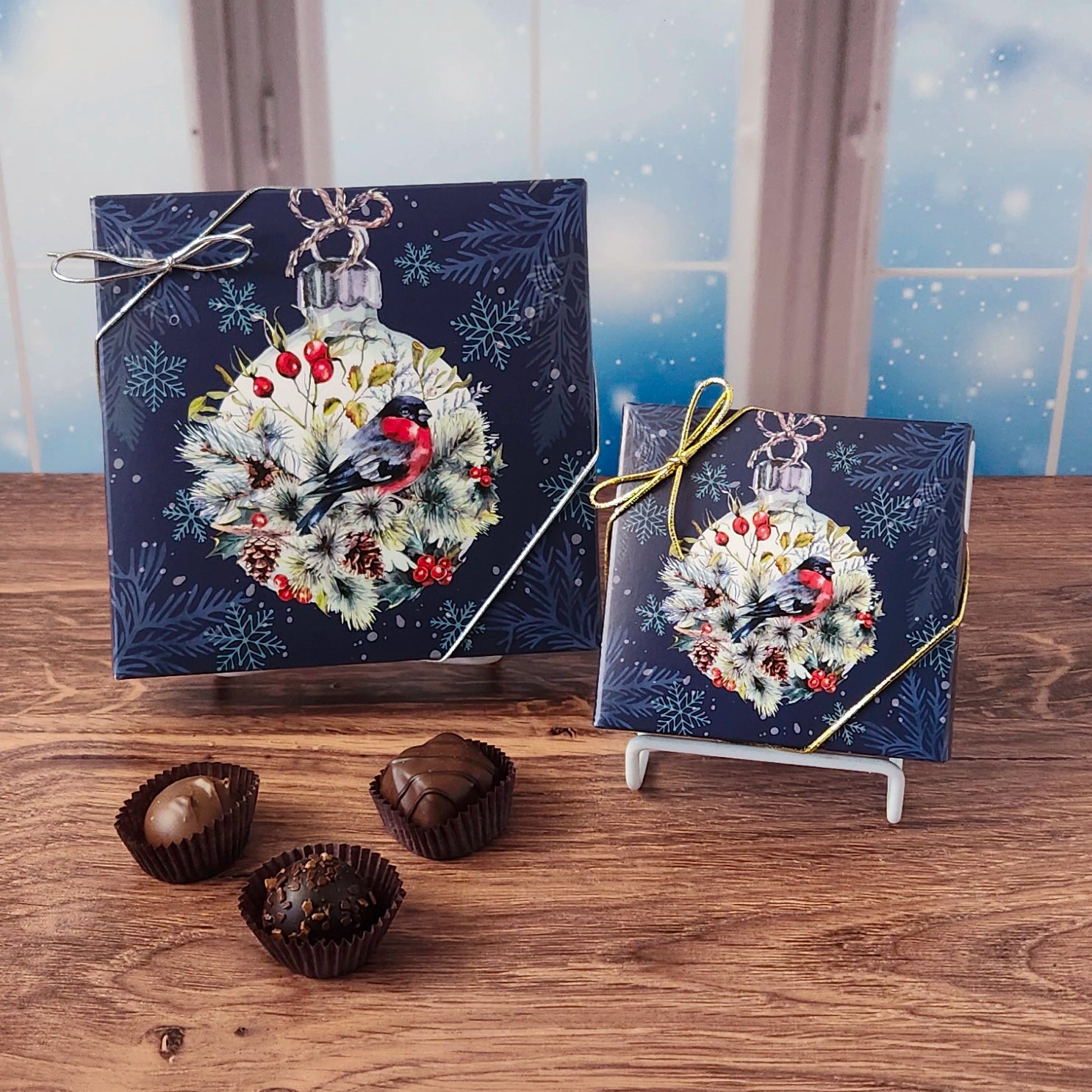 Winter Bird Chocolate Assortment.  This decorative box is filled with some of our most beloved milk and dark chocolates.  From smooth, silky creams to gooey caramels, dreamy melt-aways, and rich truffles that melt in your mouth.  Available in 9 or 16 pieces.