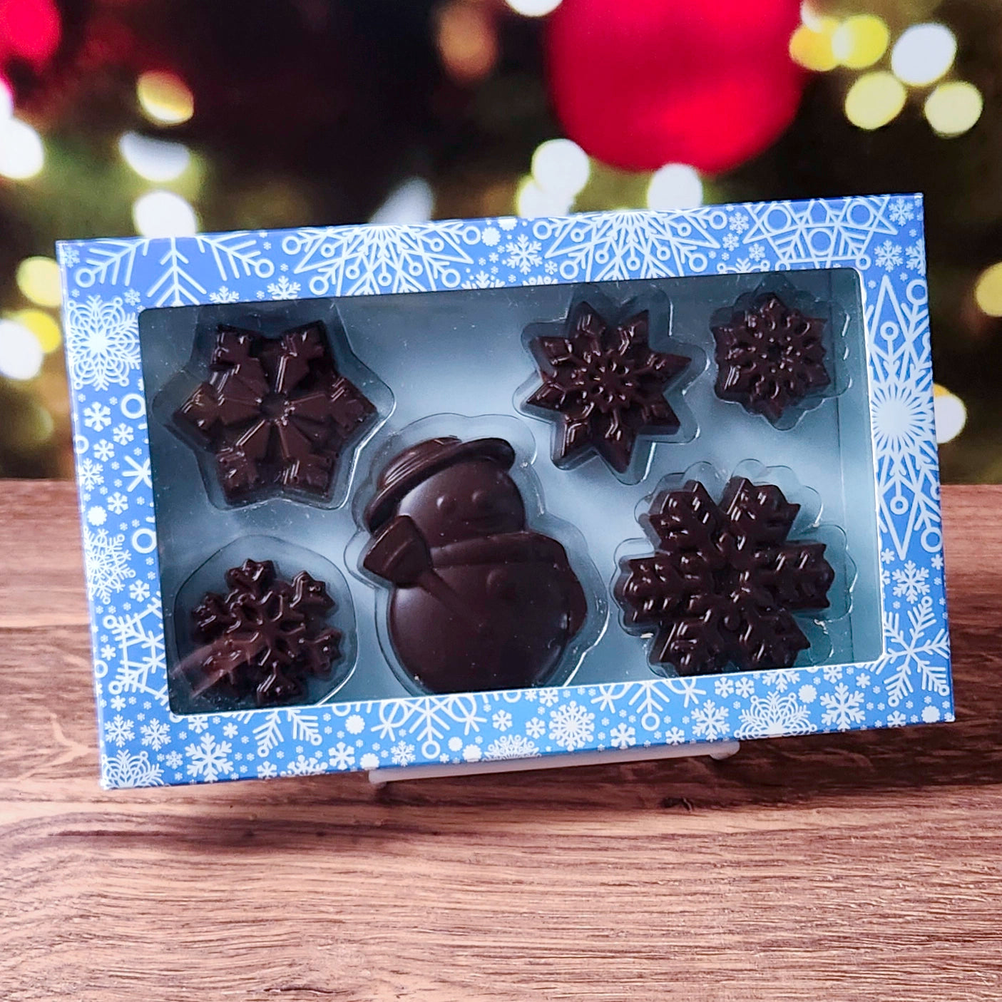 Step into a chocolatey winter wonderland with our Winter Fun Dark Chocolate Gift Box! This festive set features a charming solid chocolate snowman and five beautifully detailed chocolate snowflakes, creating a perfect seasonal treat. 