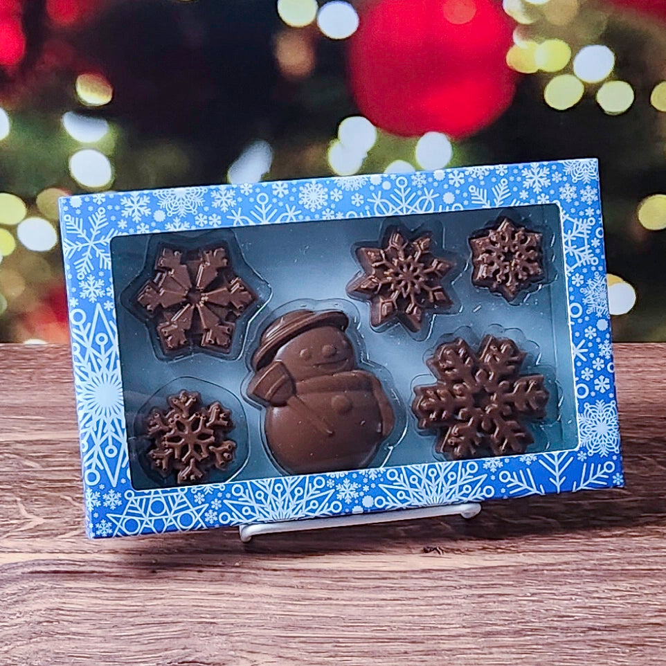 Step into a chocolatey winter wonderland with our Winter Fun Milk Chocolate Gift Box! This festive set features a charming solid chocolate snowman and five beautifully detailed chocolate snowflakes, creating a perfect seasonal treat. 