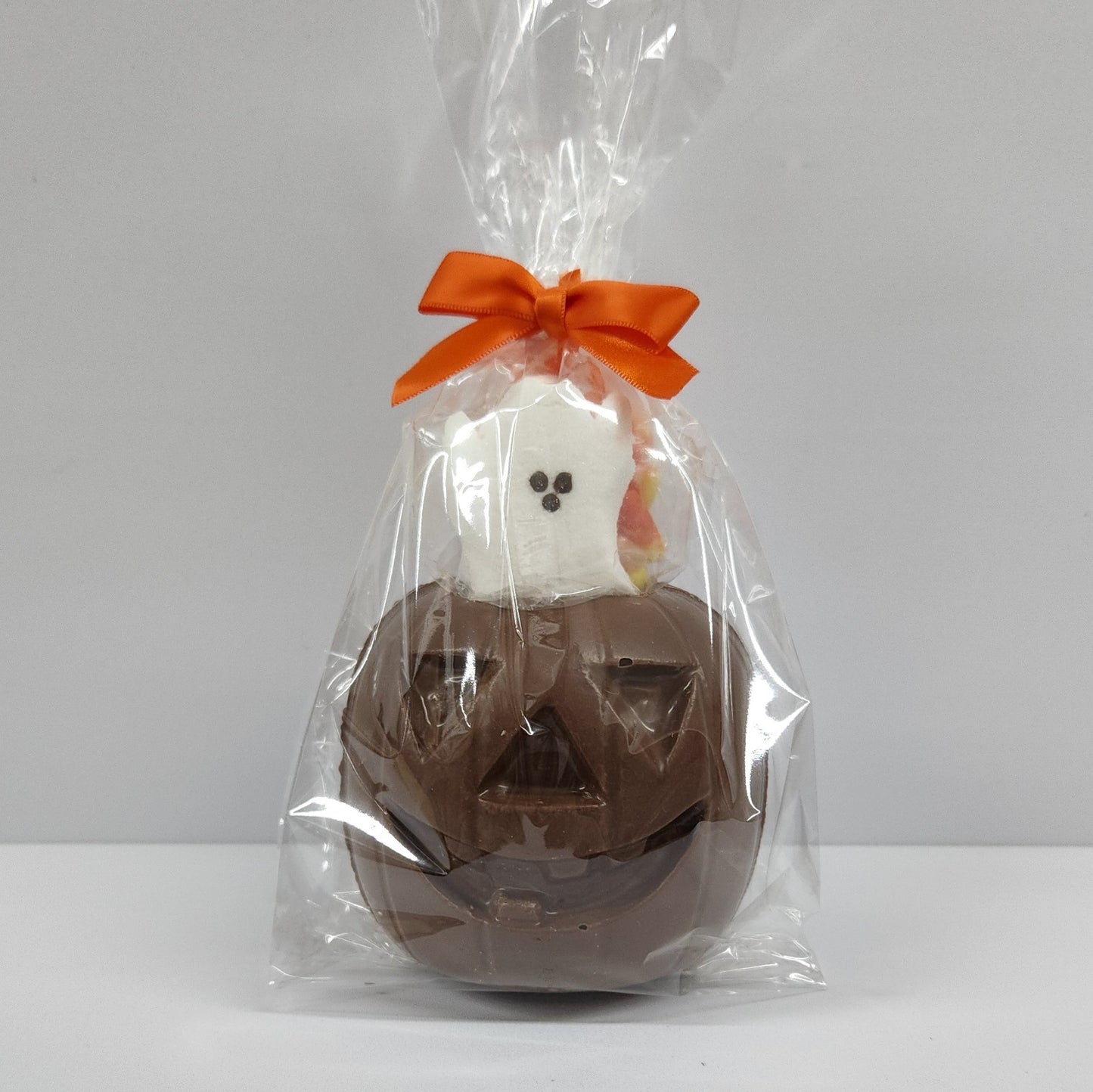 Dark Chocolate 3D Pumpkin with Orange Taffy, Candy Corn and a Ghost Peep inside. 