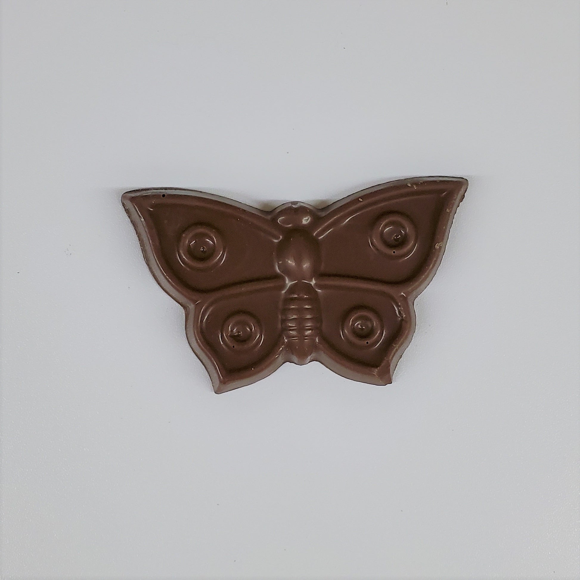 Solid milk chocolate in the shape of a butterfly