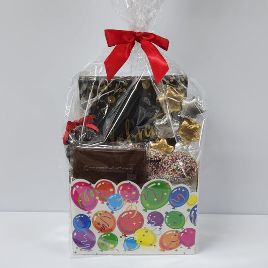 Celebrate Gift Basket from Stage Stop Candy in Dennisport, wrapped in plastic with red bow