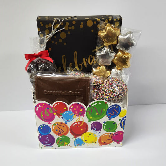 Celebrate Candy Gift Basket includes silver and gold foiled milk chocolate stars, milk chocolate nonpareils and a milk chocolate 'Congratulations' card, dark chocolate cranberries and 16 pieces of creams, caramels, meltaways and truffles.