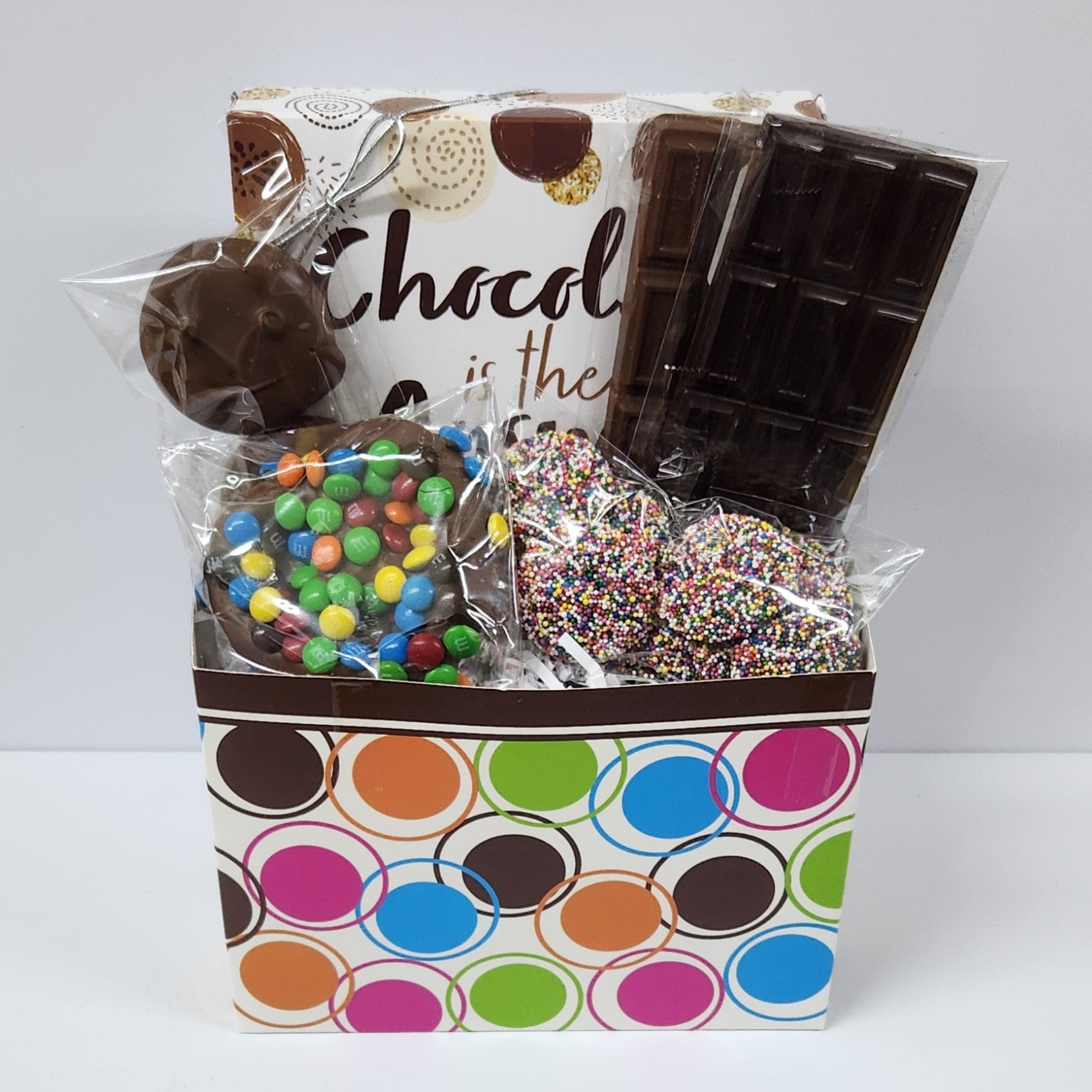 Chocolate is the Answer Gift Basket includes milk & dark chocolate candy bars, milk chocolate covered Oreos, milk chocolate nonpareils, a milk chocolate covered pretzels coated in mini M & M's and a 16 piece assortment of caramels, truffles and meltaways