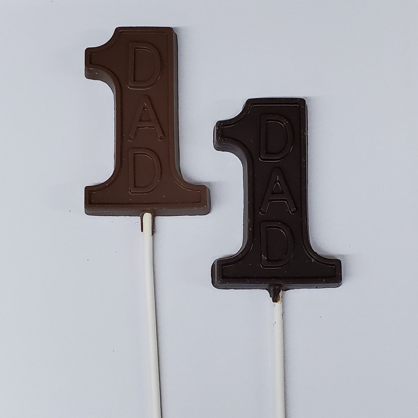 Milk and Dark Chocolate lollipops with the word 'Dad'