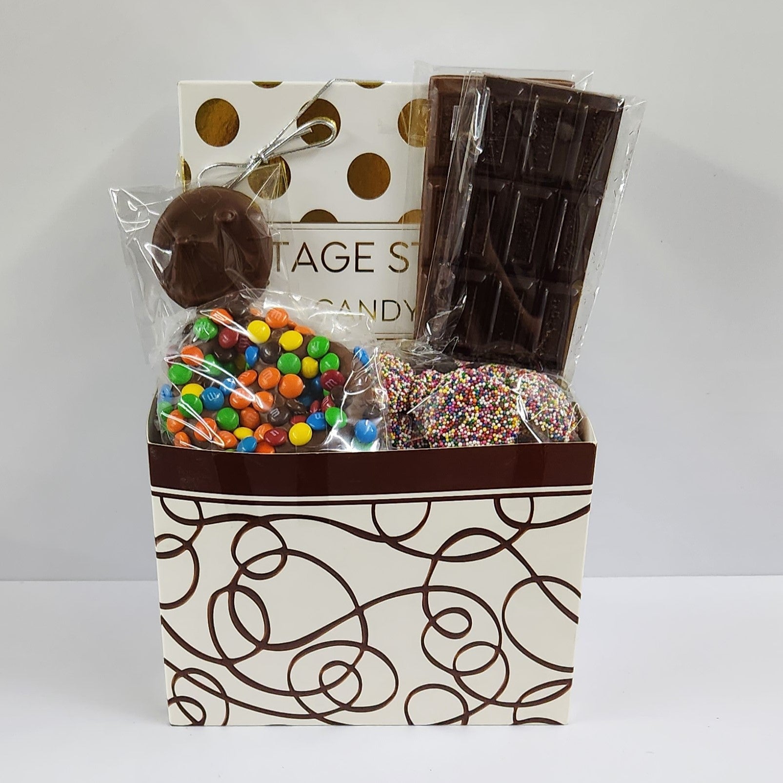 All Occasion Chocolate Drizzle Gift Basket includes Sweet Swirls Gift Baskets includes a 16-piece assortment of creams, caramels, meltaways and truffles, milk & dark chocolate candy bars, milk chocolate covered Oreos, milk chocolate nonpareils and a milk chocolate covered pretzels coated in mini M & M's. 