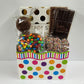 A chocolate gift basket for every occasion! This polka dotted present includes Sweet Swirls Gift Baskets includes a 16-piece assortment of creams, caramels, meltaways and truffles, milk & dark chocolate candy bars, milk chocolate covered Oreos, milk chocolate nonpareils and a milk chocolate covered pretzels coated in mini M & M's. 