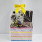 Sweet Swirls Chocolate Gift Basket from Stage Stop Candy wrapped in plastic and tied with a yellow bow.