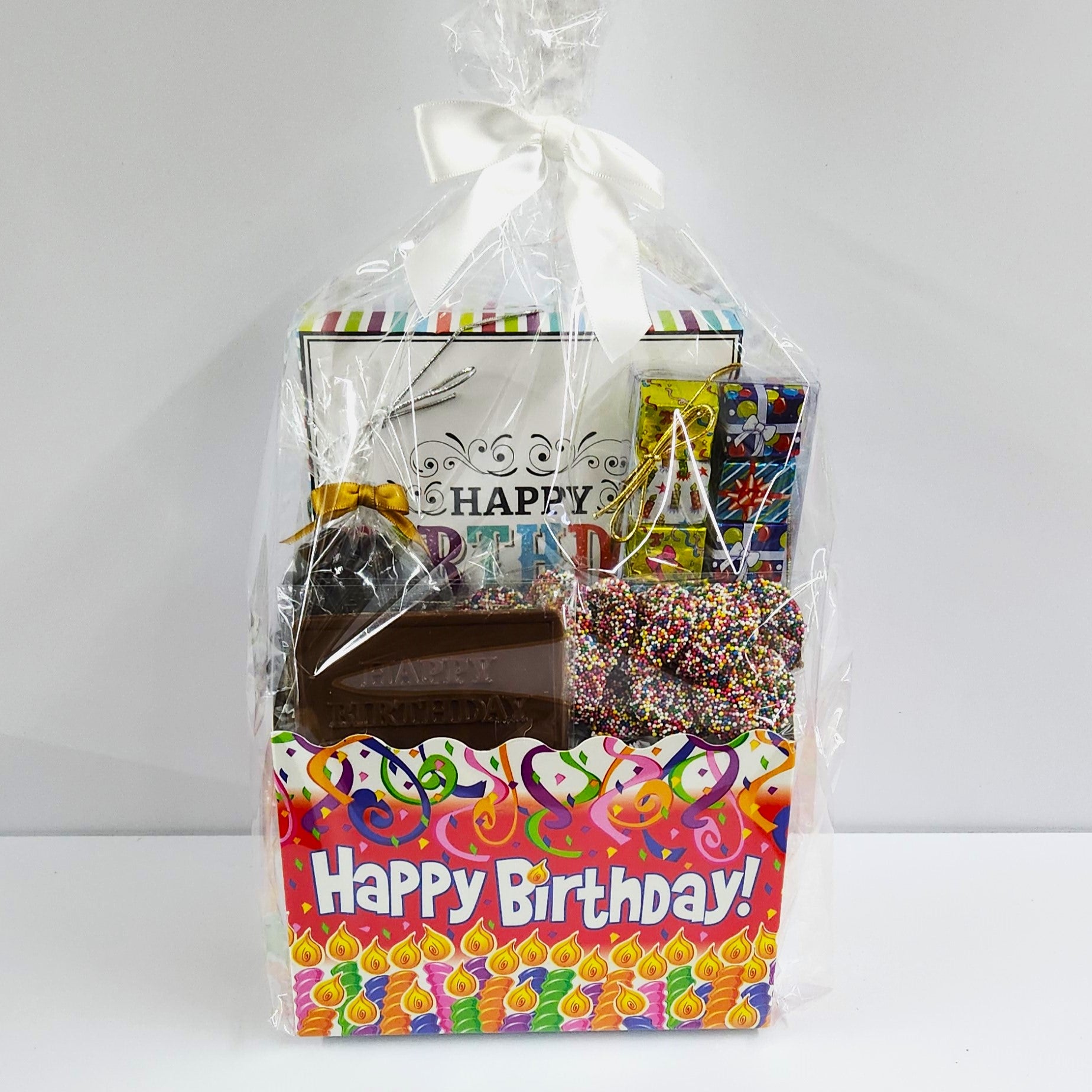 Happy Birthday Celebration Candy Gift Basket from Stage Stop Candy in Dennisport, MA, wrapped in plastic with a white bow