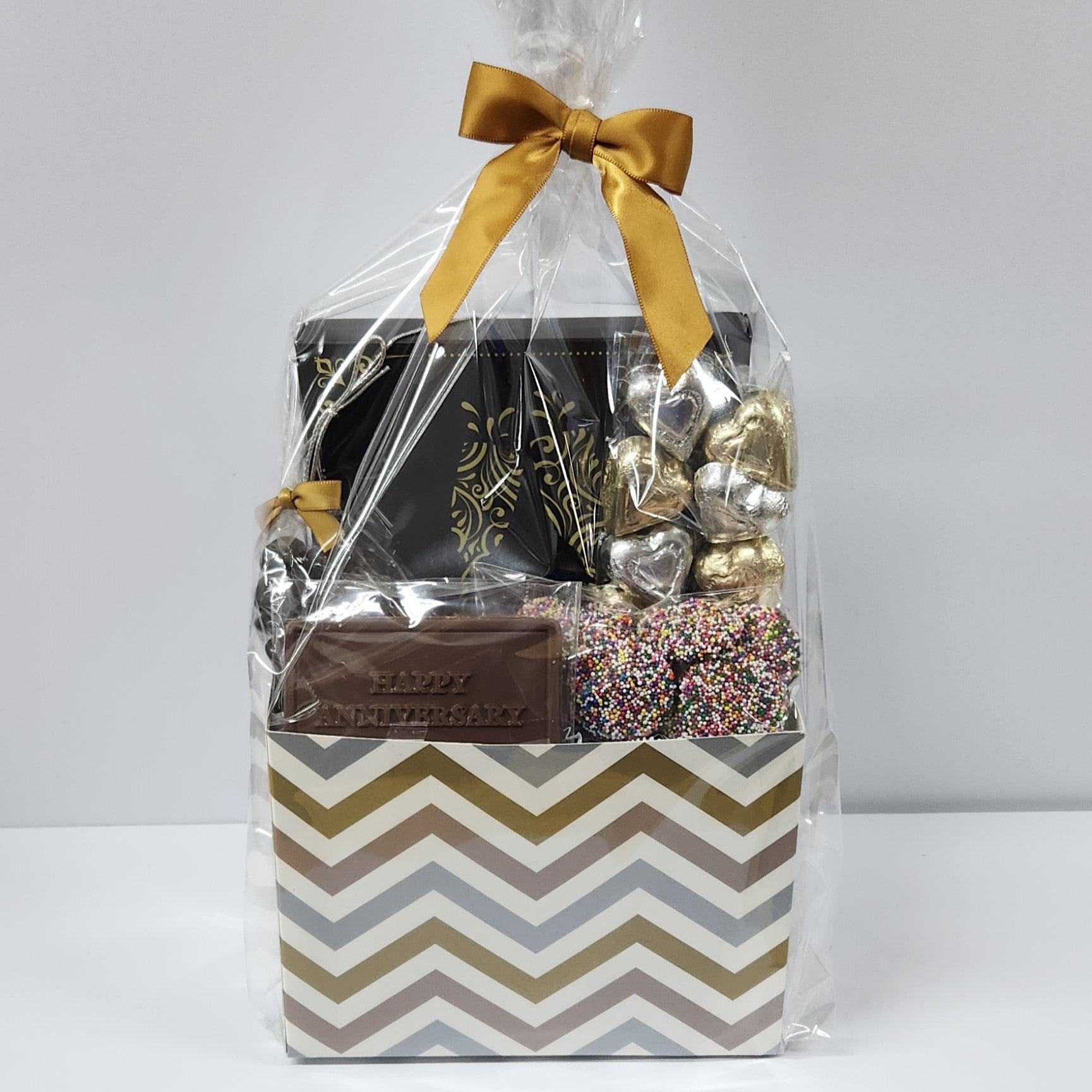 Happy Anniversary Chocolate Gift Basket from Stage Stop Candy wrapped in plastic with a gold bow