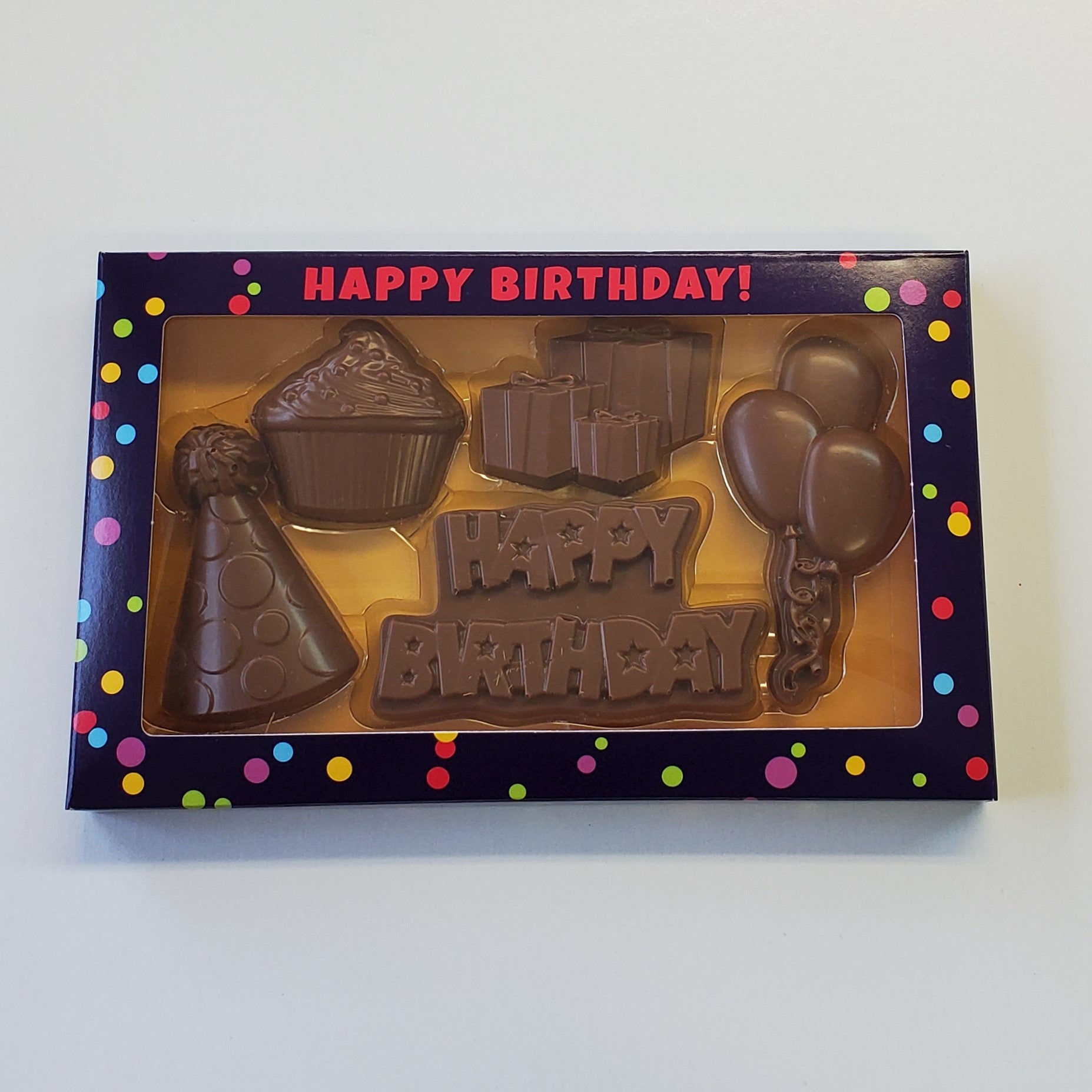Milk Chocolate Happy Birthday Box Gift Set includes a party hat, cupcake, presents, balloons and Happy Birthday shaped chocolates