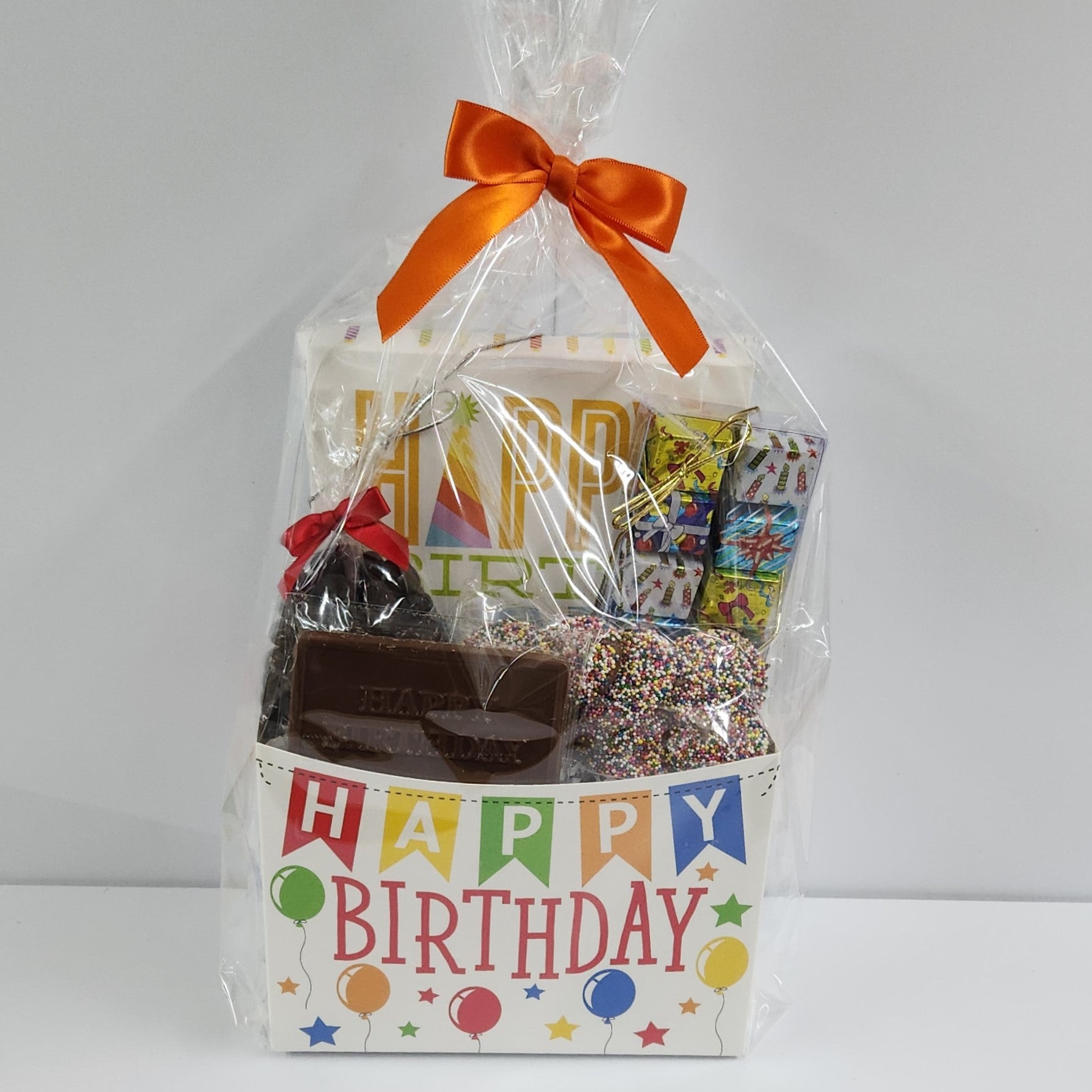 Happy Birthday Candy Gift Basket from Stage Stop Candy wrapped in plastic with an orange bow