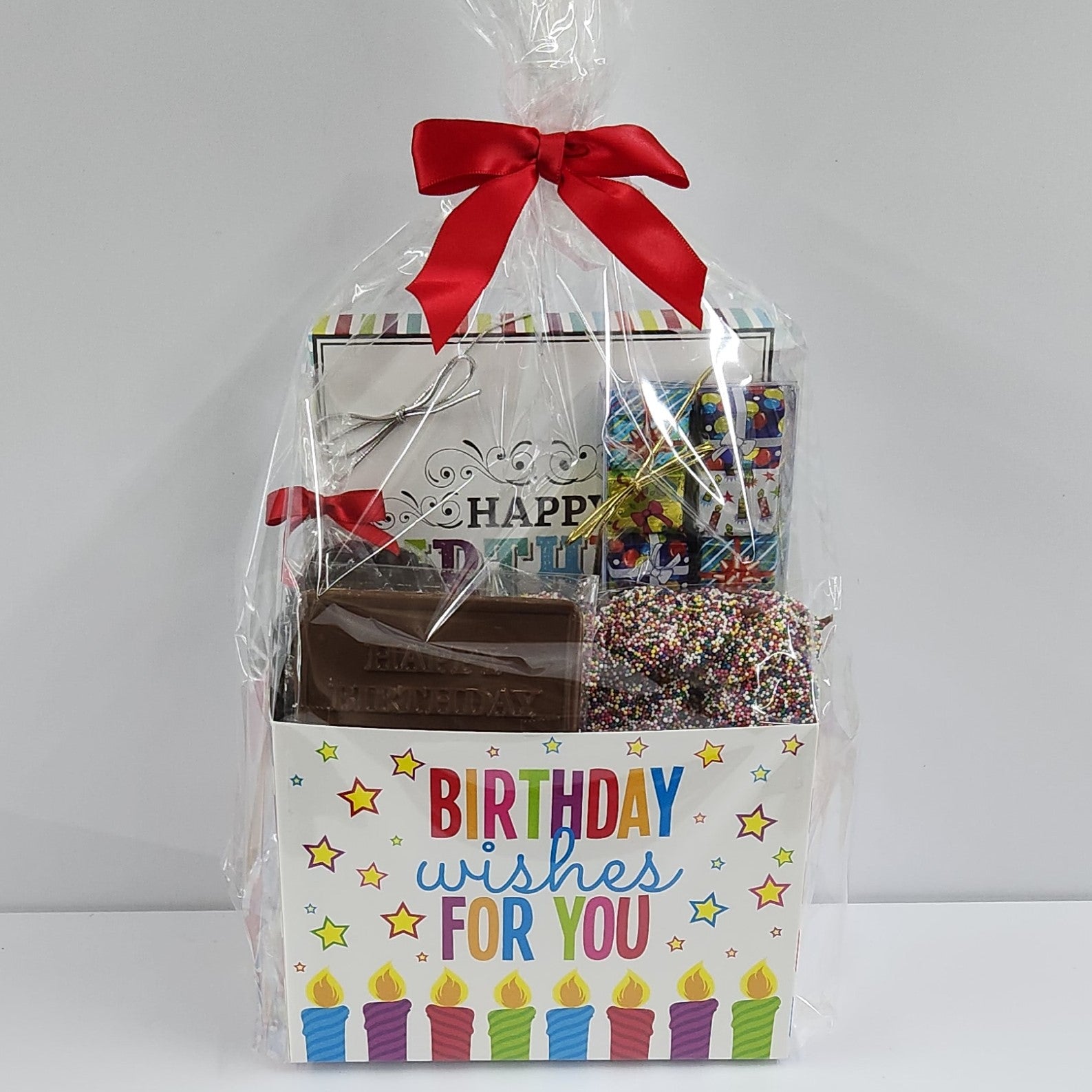 Birthday Wishes Candy Gift Basket from Stage Stop Candy wrapped in plastic with a red bow