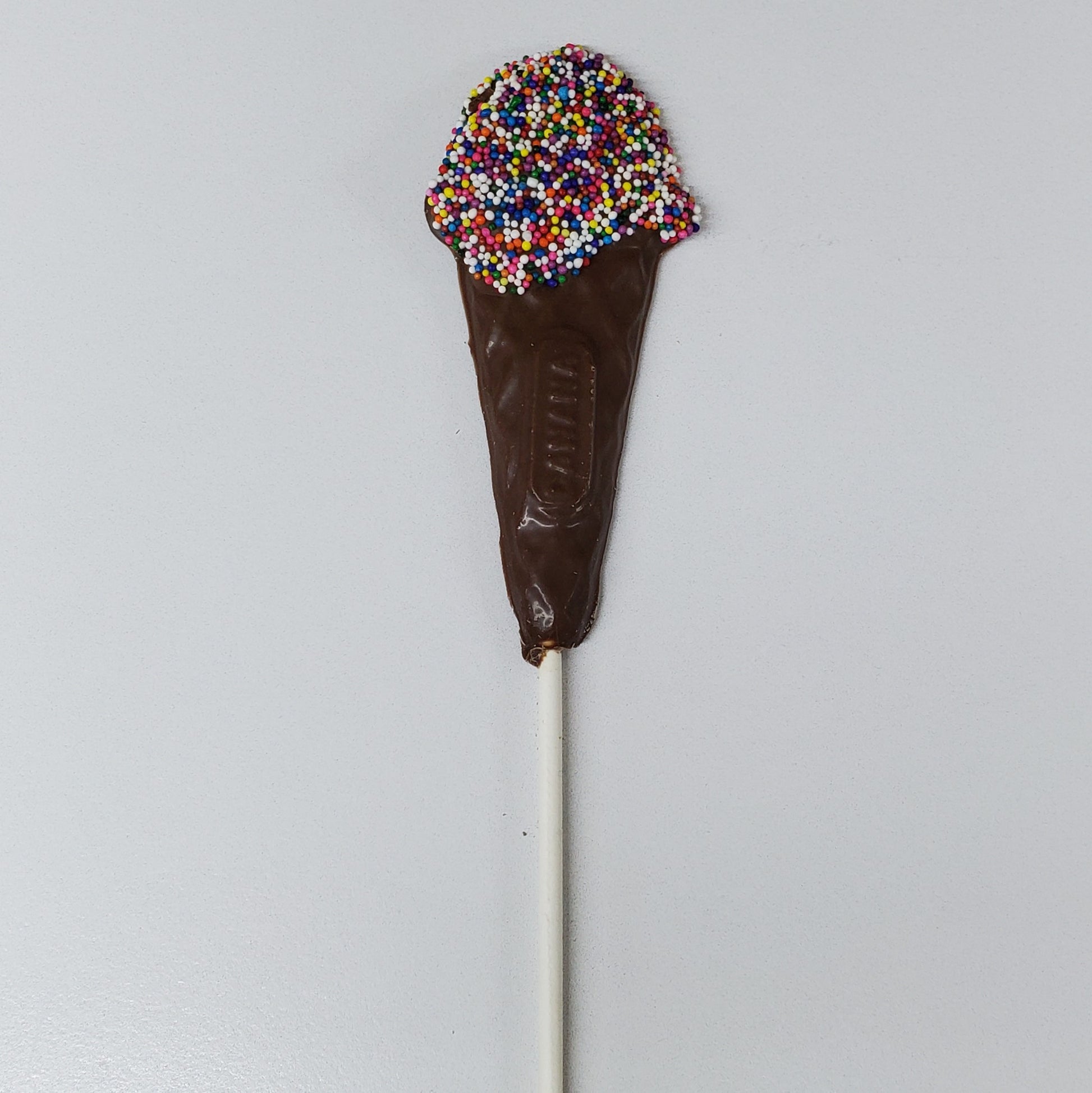 Milk Chocolate shaped into an ice cream cone with rainbow nonpareils