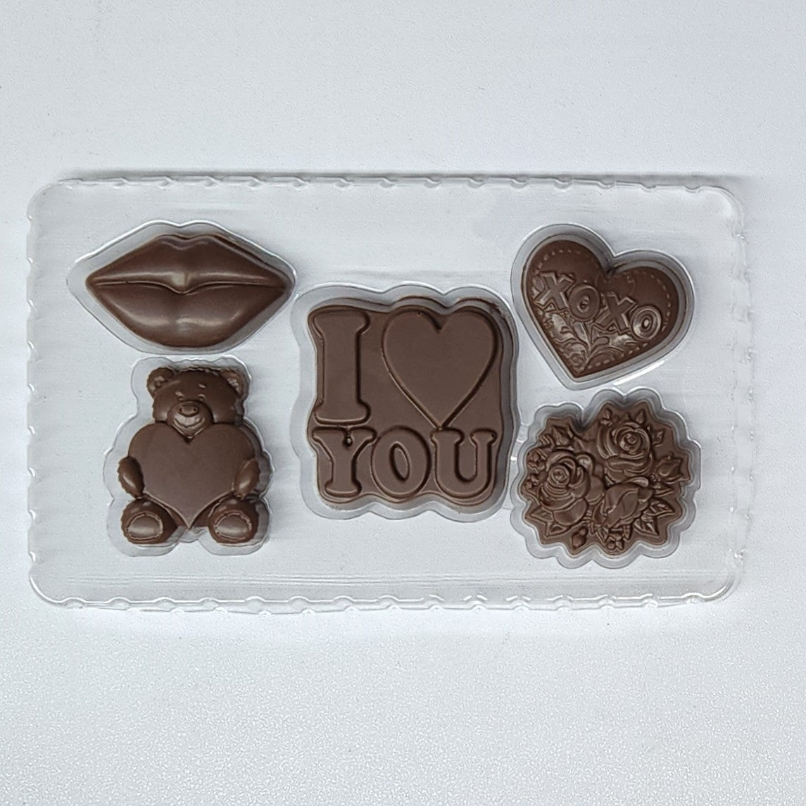 Valentine's Day Chocolate Gift Box set with chocolate lips, teddy bear, heart, flowers and 'I love you'