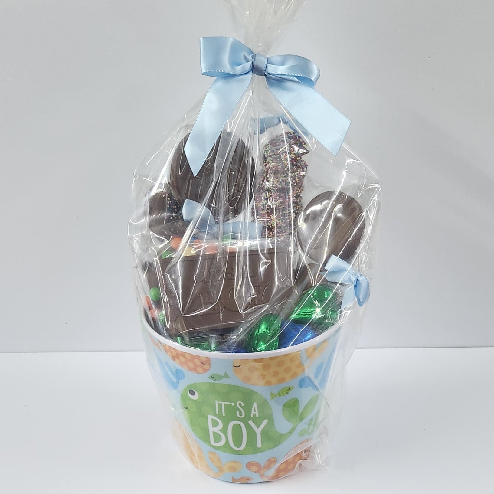 Stage Stop Candy It's a Boy Chocolate Gift Basket wrapped in plastic with a blue bow
