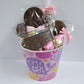 It's a Girl Gift Basket includes Milk Chocolate Nonpareils, Milk Chocolate covered Oreos, Shortbread Cookies, and a M&M-covered pretzel, pink foiled milk chocolate hearts and a special milk chocolate card and lollipop that say "It's a Girl!".