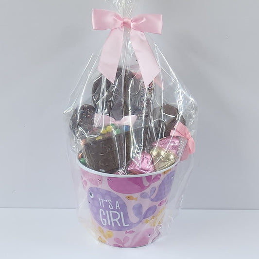 It's a Gift Chocolate Gift Basket from Stage Stop Candy wrapped in plastic with a pink bow