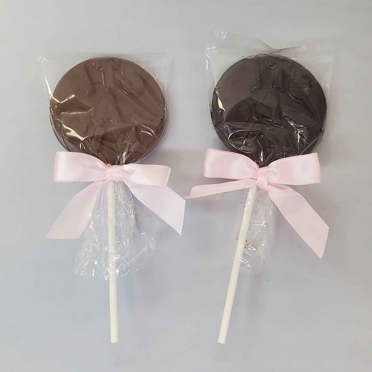 Milk and Dark Chocolate It's A Girl lollipop with pink bows