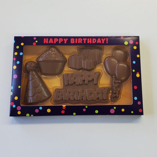 Milk Chocolate Happy Birthday Box Gift Set includes a party hat, cupcake, presents, balloons and Happy Birthday shaped chocolates