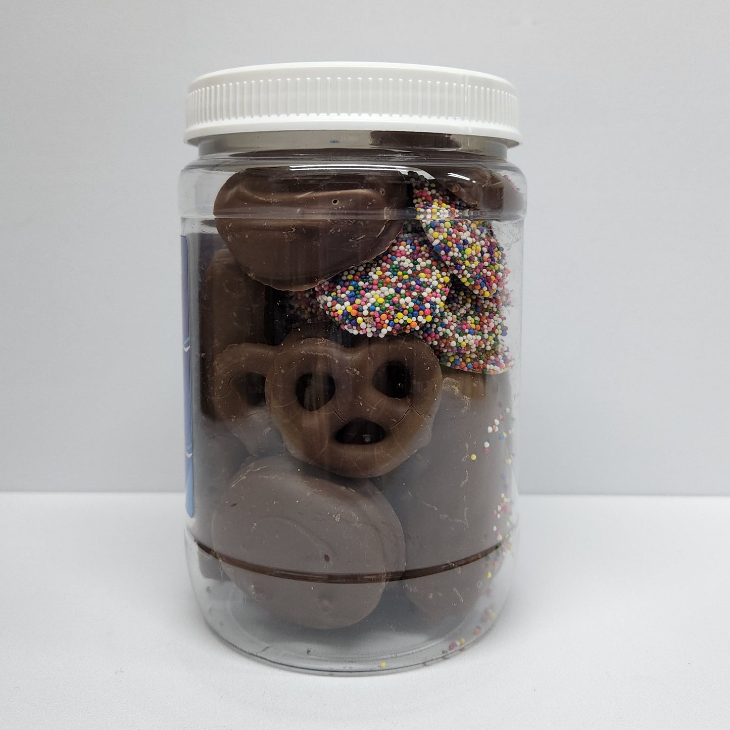 Chocolate Covered Oreos, Pretzels, Wafer Cookies, Shortbread Cookie, a Rice Krispie Treat, a Twinkie, and Nonpareils in a jar