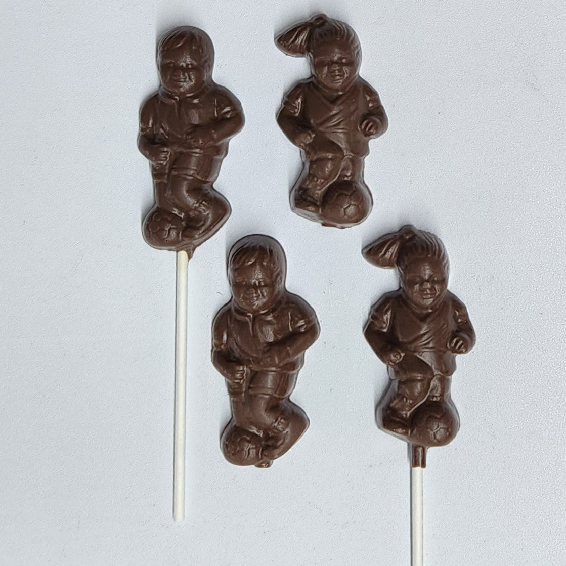 Solid milk chocolate soccer kids, available as favors or lollipops