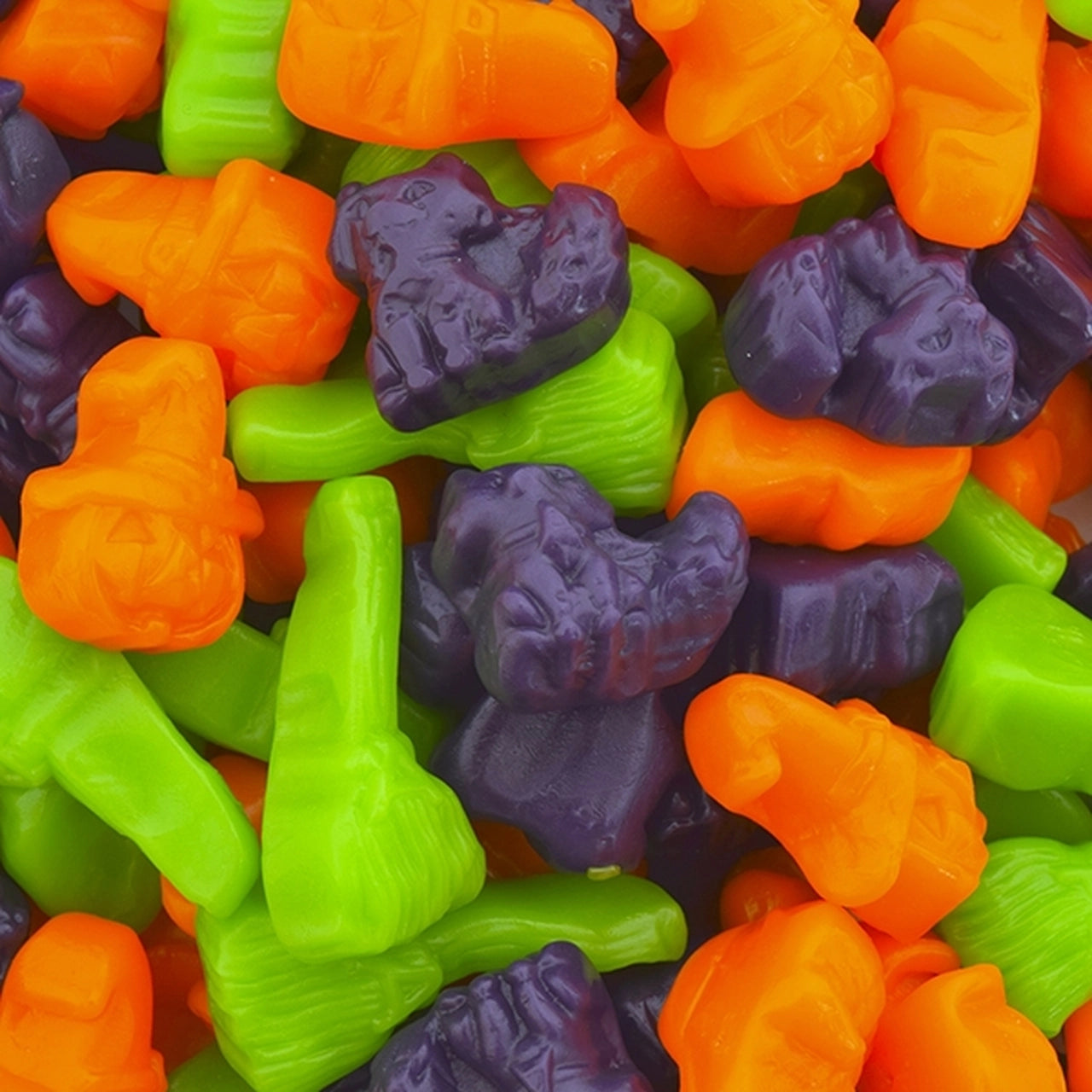 Halloween Gummy Mix with Orange flavored jack-o'-lanterns, Grape flavored kittens, and Green Apple flavored witches' broomsticks.