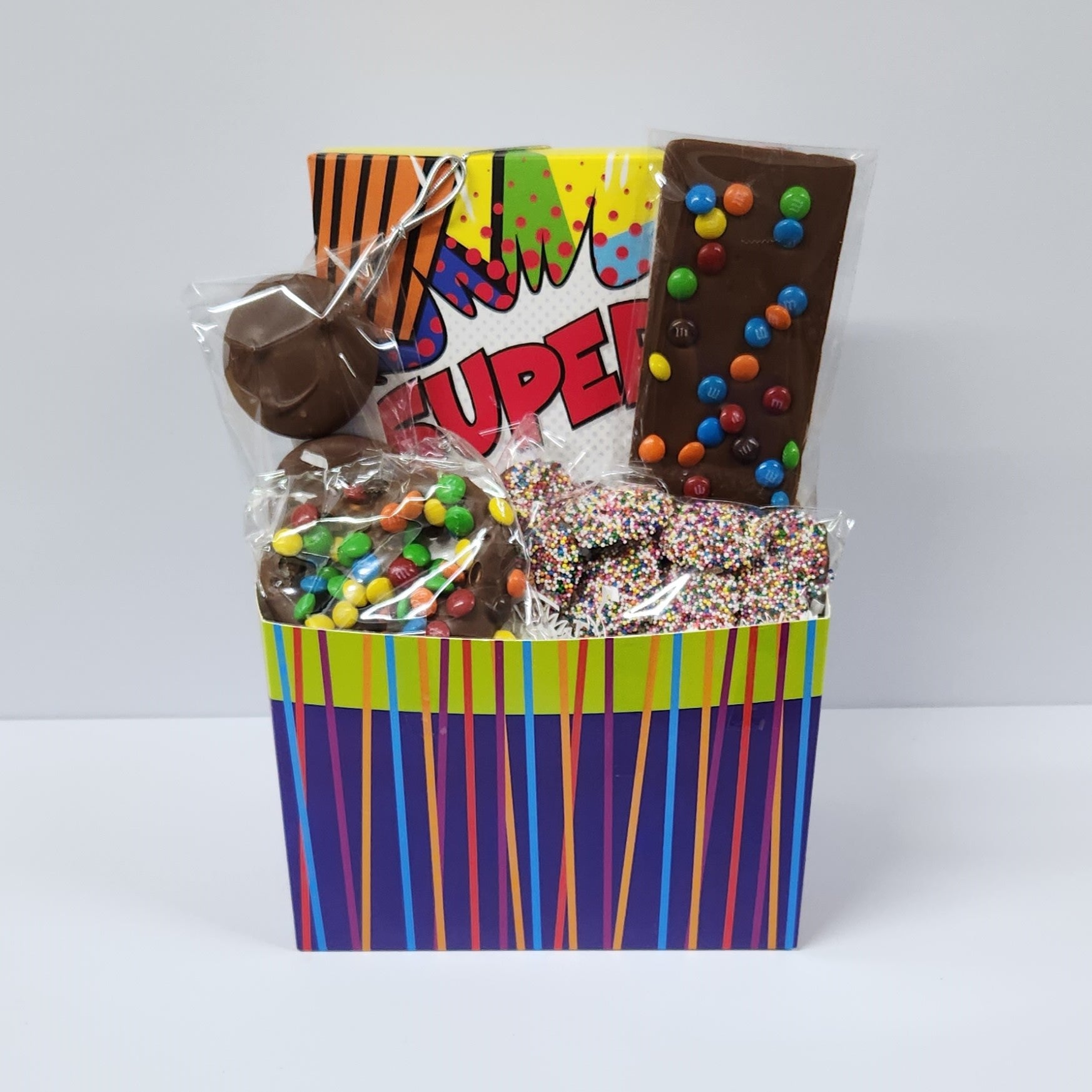 The Super Gift Basket includes Milk Chocolate covered Oreos, Nonpareils, an M & M Pretzel, Milk Chocolate Fun Bar with mini M&M's and 16-piece assortment of creams, caramels, meltaways and truffles