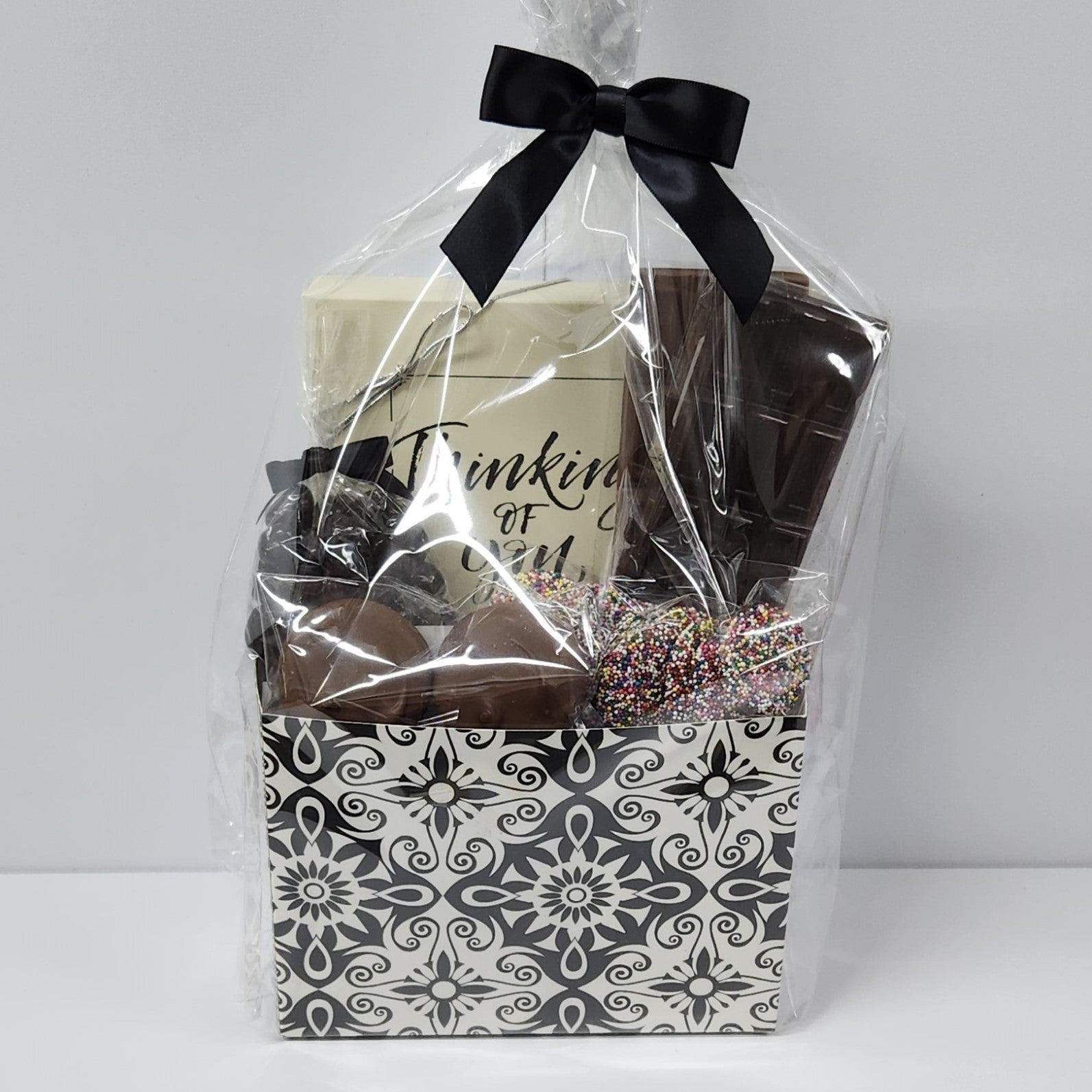 Chocolate Thinking of You Gift Basket wrapped in plastic and tied with a bow — the perfect present for anyone! 