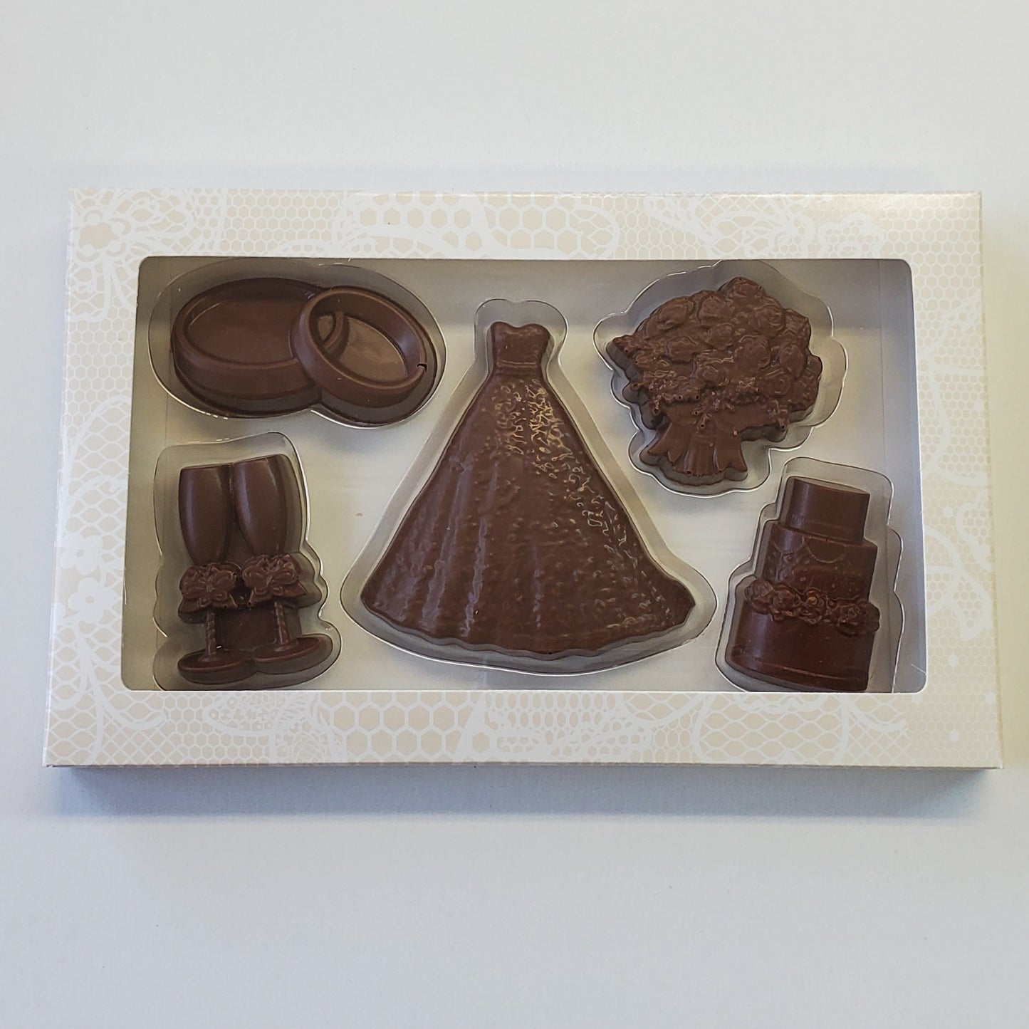Milk Chocolate Wedding Box Set includes chocolate rings, champagne flutes, wedding dress, flowers and cake shapes